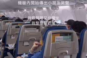 Passengers hold oxygen masks to their faces after their plane dropped 26,900ft.
