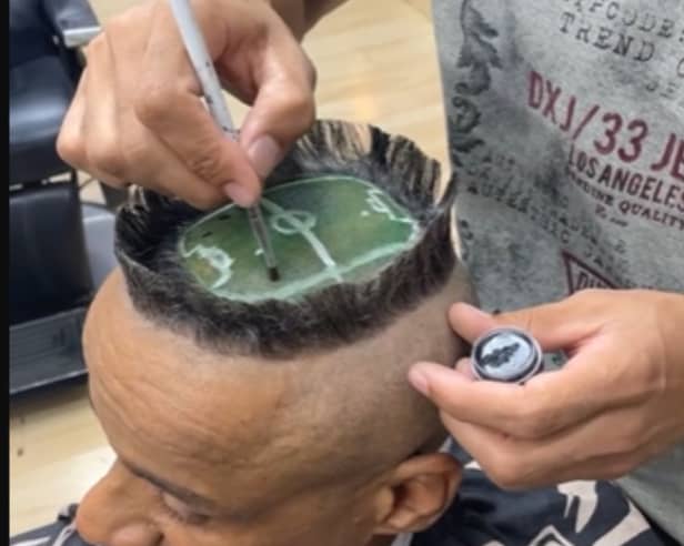 A hair artist created a miniature football stadium on a client's head.