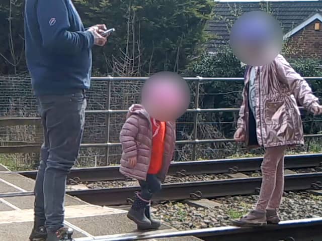 Shocking footage shows young children being played on the tracks 