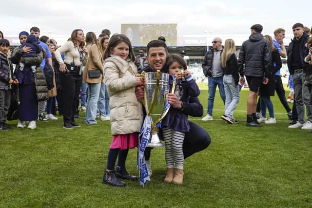 John Mousinho celebrates the League One title with his two daughters on the pitch at Fratton Park. Picture: Jason Brown/ProSportsImages