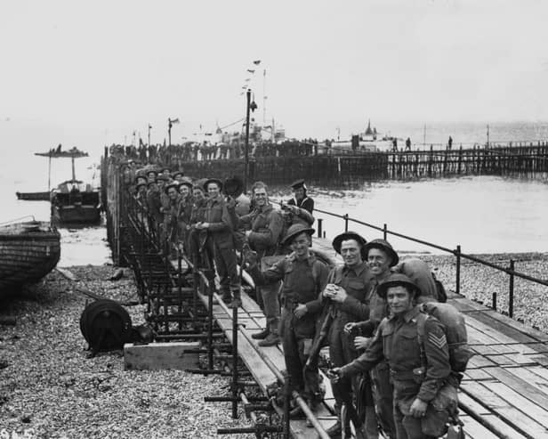 Troops line up on a temporary pier in Southsea as they wait to embark