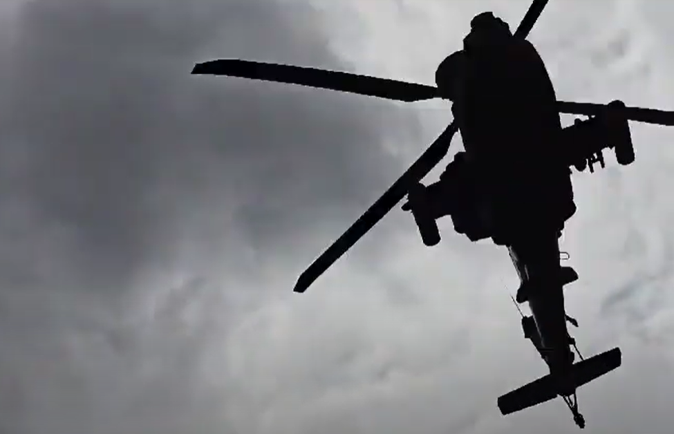 Video shows terrifying Apache gunship roaring overhead in low pass over village